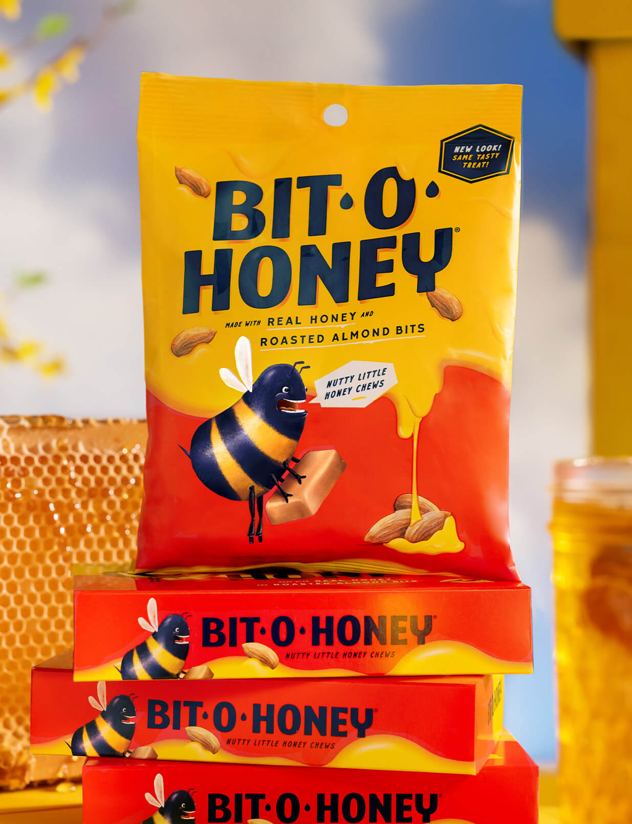 Bag of Bit-O-Honey candies stacked on top of three Bit-O-Honey boxes